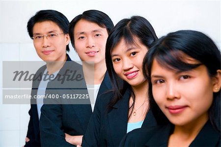 Young Asian business people line up, with focus on the second front woman (Chinese woman)