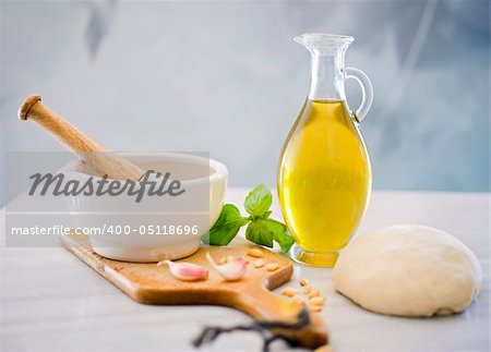 dough, mortar and pestle, olive oil, bazil and garlic