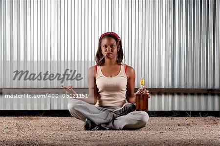 Woman meditating with cigar and tequila bottle