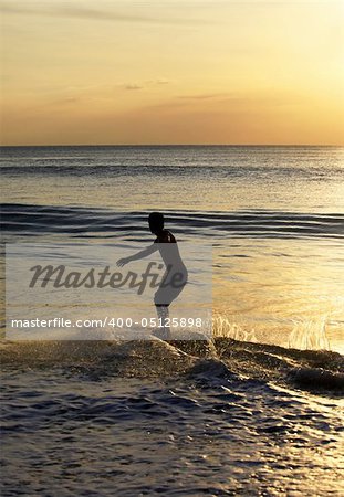 Young men - the surfer in ocean. Bali. Indonesia