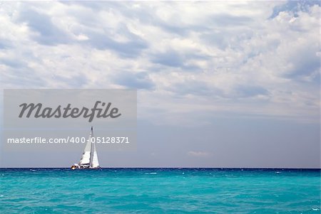 Lonely sailing boat at azure sea