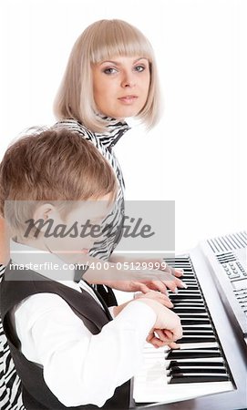 Mother and son playing piano together