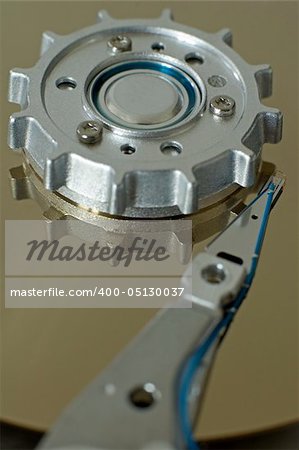 opened hard disk drive, data head and silver cylinder