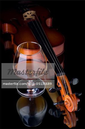 Snifter glass of cognac and violin