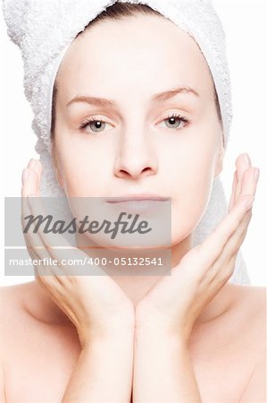 Woman in towel with hands near her face