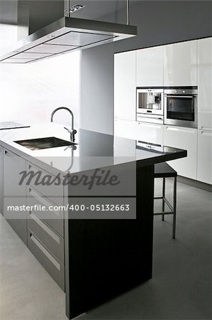 Interior of white kitchen with big counter