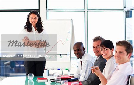 Confident businessteam looking at the camera in a presentation