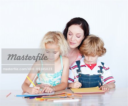 Mother and children writing together at home