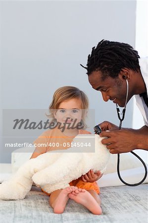 Pediatrician exams a little girl with stethoscope in a hospital