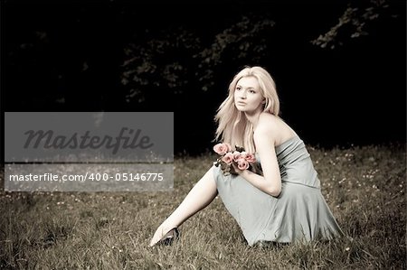 Pretty Woman Sitting OnThe Meadow