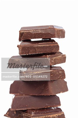 Blocks of chocolate isolated on white background. Shallow depth of field