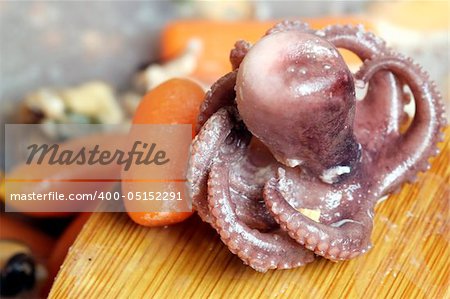 Seafood cooked with vegetables in a pan.