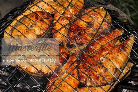 Salmon cooking on grill
