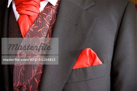 suit jacket of groom and red cravat ascot tie