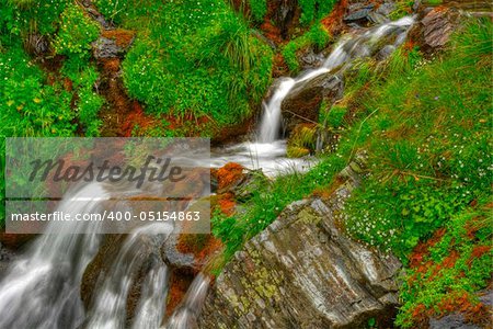 beautiful cascade in the morning light,  HDR. Long exposure time gives an "out of time" feeling.