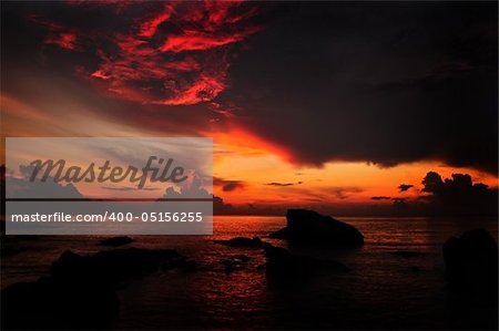 Sun rising over water horizon at Teluk Cempedak (Jackfruit Bay), a famous beach in Kuantan, Pahang, Malaysia, Asia.