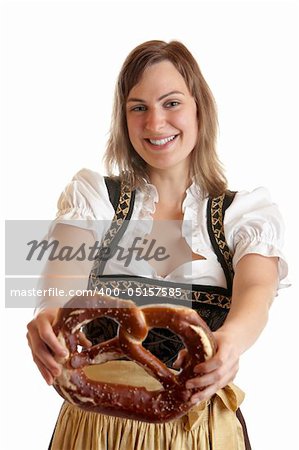 Bavarian Girl wearing original Dirndl and holding Oktoberfest Pretzel in her hands