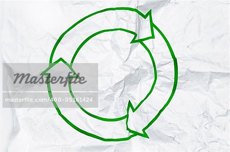 Green recycling symbol on white crumpled paper