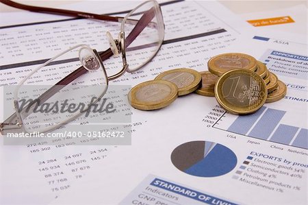 Business background: Financial reports, euro coins and glasses