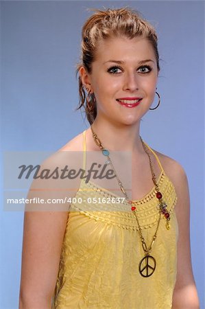 Pretty auburn haired teenager in a hippie-inspired yellow blouse