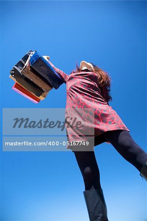 woman on red dress with shopping bags
