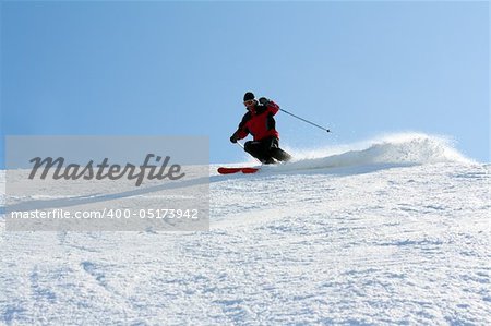 Man in red jacket goes on mountain ski