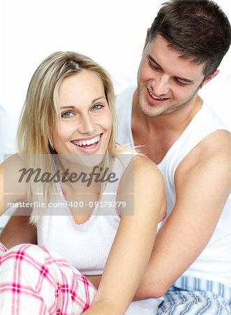 Young lovers together sitting on bed