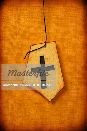 Close up of handmade paper tag with holy cross