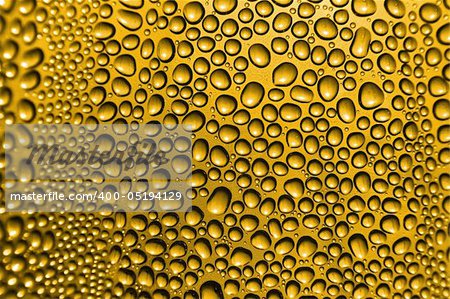 golden beer background with the water drops