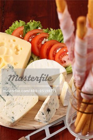 Cutting board with different kinds of cheese