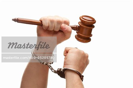 Handcuffed Man Holding Wooden Gavel in His Fist Isolated on a White Background.