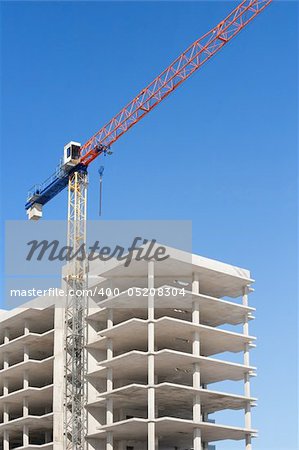 concrete building construction with crane