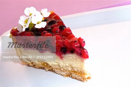 Slice of fruit cake with white decorative flowers