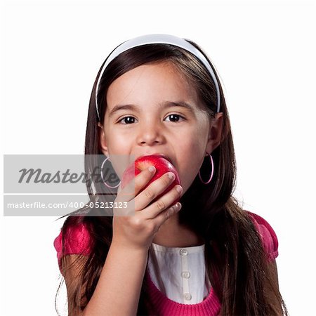 Girl bites into a fresh organic apple