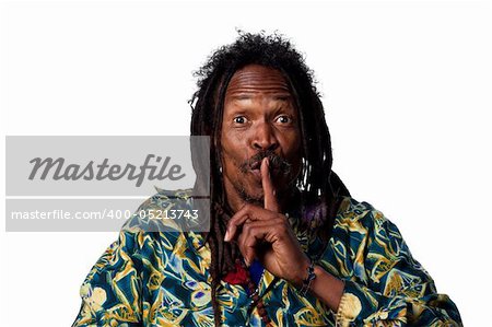 Man with fingers on his lips, telling people to be quiet