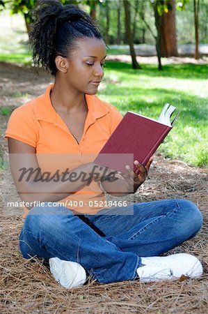 A young African American woman reading a book