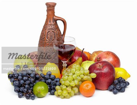 Artistic composition of fruit and jug of wine on white