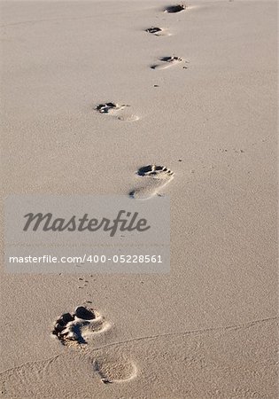 Footprints on a beach in wet sand