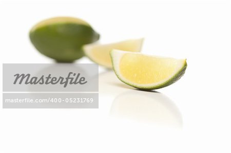 Sliced Lime on a Reflective White Surface.