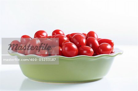 grape tomatoes in a bowl on white