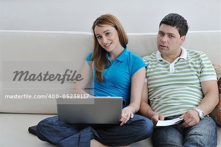 young couple at home with  modern living room indoor working on laptop on house finance and planing