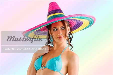 summer portrait of a cute girl wearing a bikini colored scarf and a big colorful hat like a sombrero