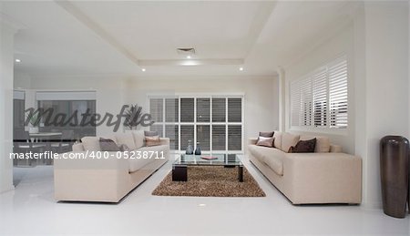 Luxury home living room interior overlooking dining room