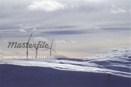 aerogenerator electric windmills snow mountain blurred foreground