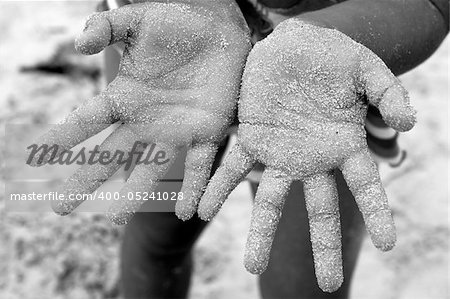 children girl beach sand palm hands facing camera summer metaphor