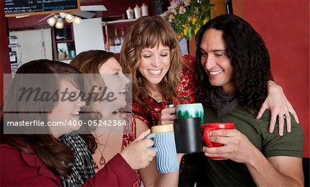 Three cute girls flirting with a handsome Native American man at a cafe