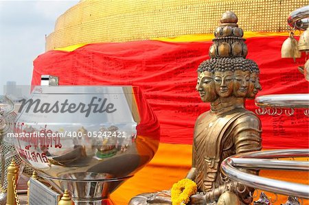 Golden statue of Buddha with many faces. Golden Mount temple, Bangkok, Thailand