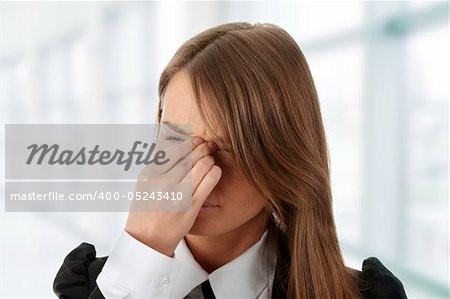 Young woman suffering a headache isolated on white background