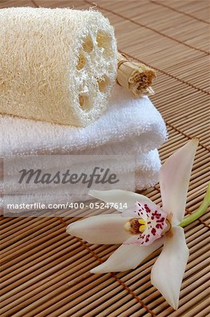 wellbeing concept with towel, candle and flower