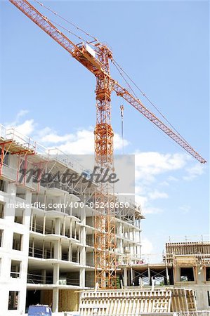 wide view of engineering architectural development outdoors unfinished exterior building in construction , machinery and material